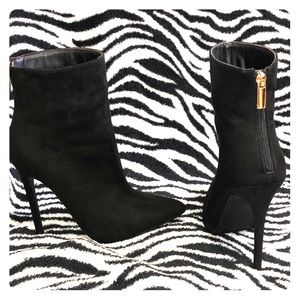 Black booties with gold zipper. Make me an offer.